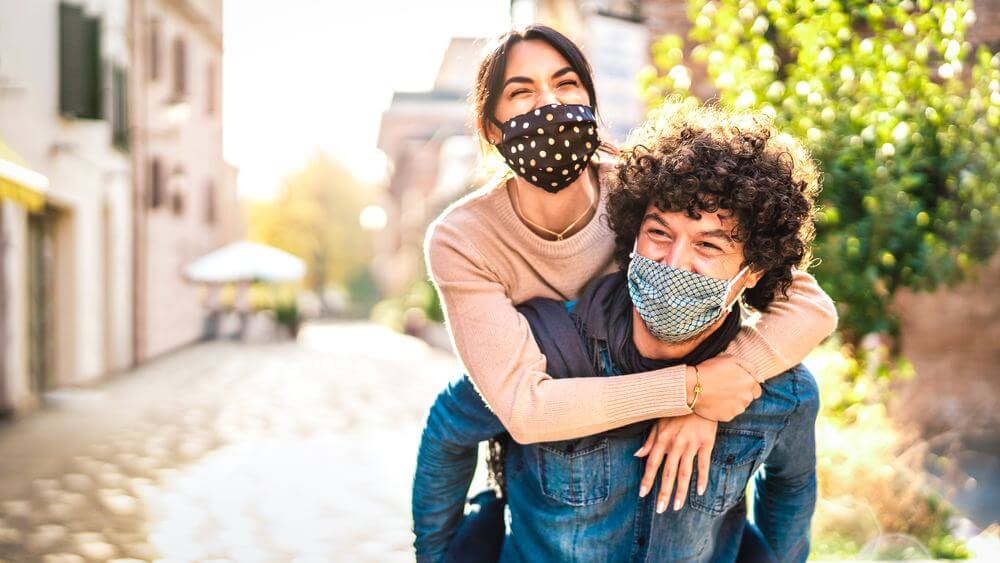 young happy couple - man piggy back his girlfriend