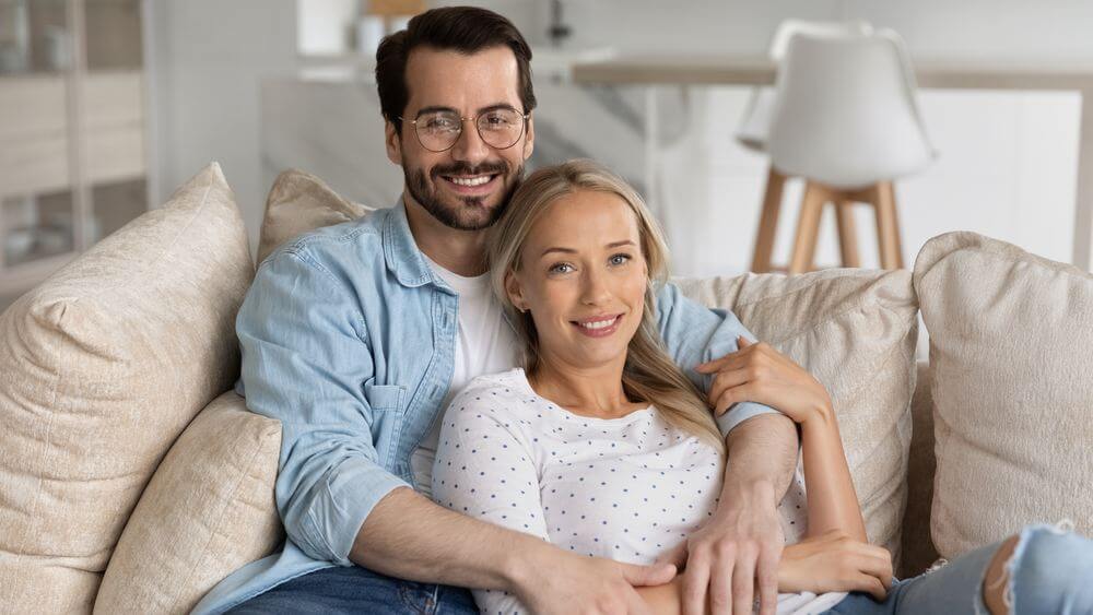 lovely couple having a good time cuddling on the sofa