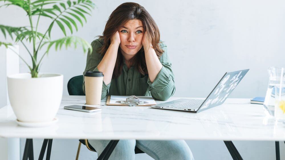 working woman looking unhappy with hands on chin