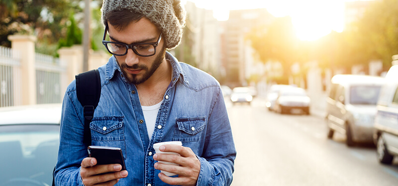 Modern young man with mobile phone