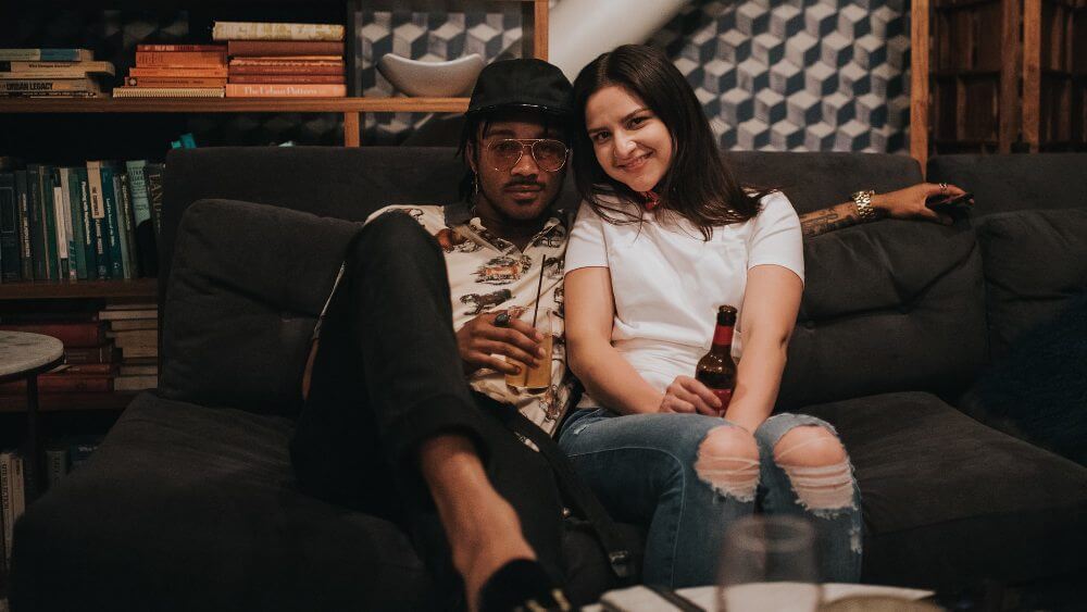 couple having a nice time on a black couch