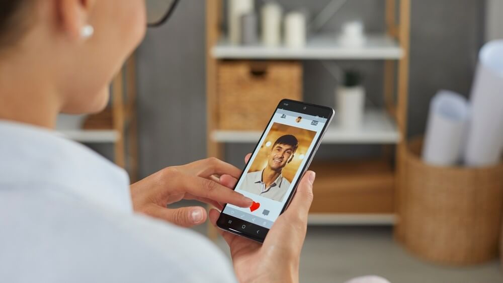 woman liking a handsome man's photo on a dating app