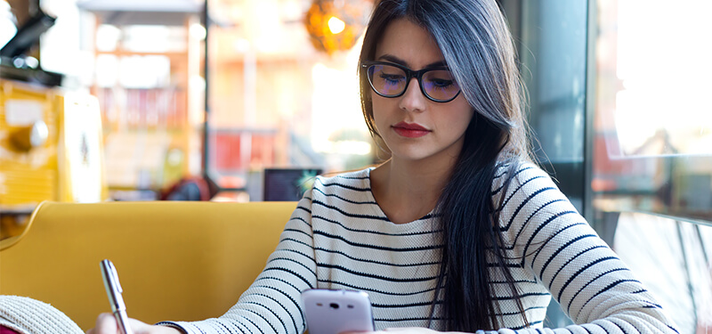 Young beautiful woman using her mobile phone