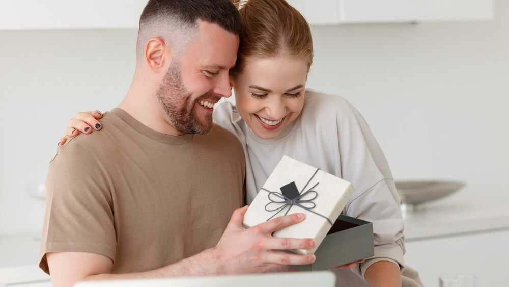 happy husband giving a gift to his wife