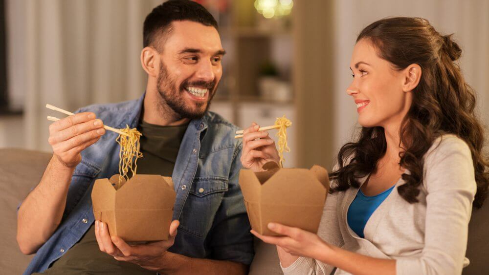 happy young couple enjoying Chinese takeout