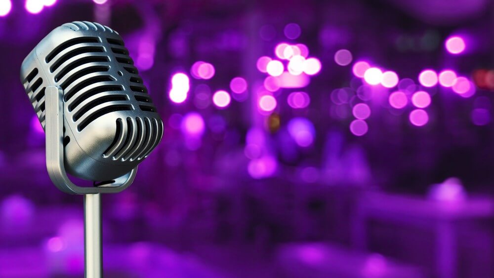 vintage karaoke mic in purple lights background