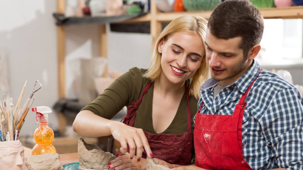 couple learning clay sculpting together