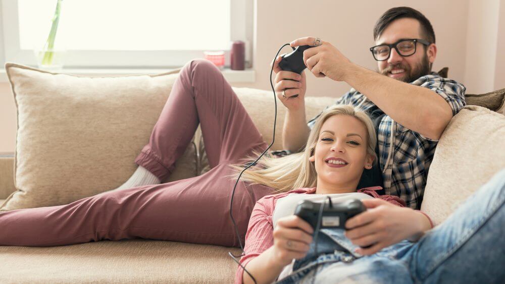 lovely young couple enjoying video games on their couch