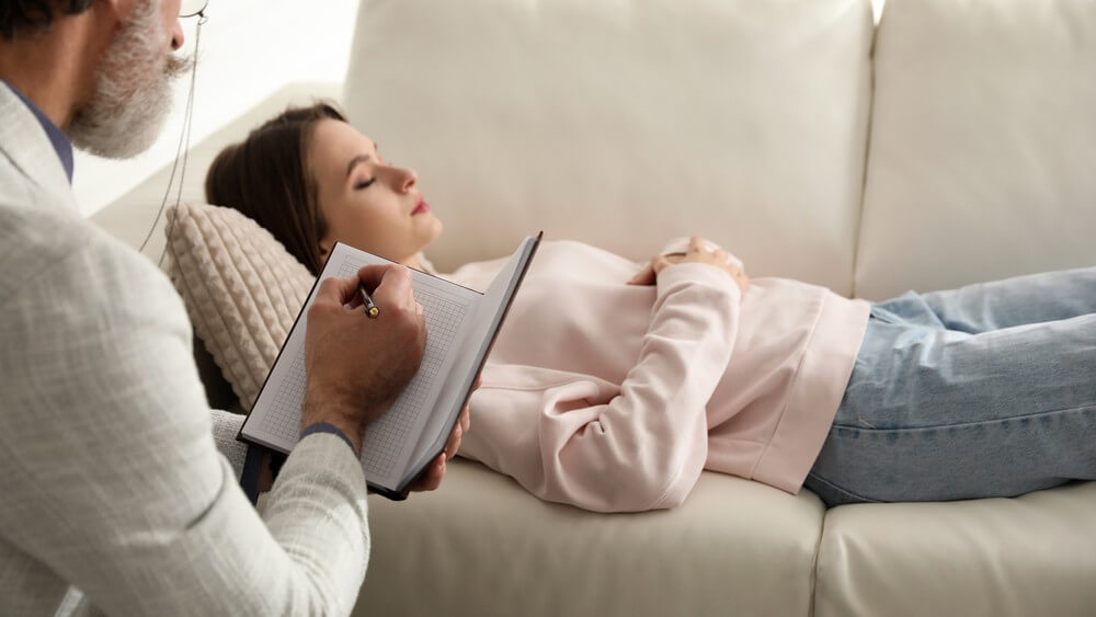 Male Psychotherapist with female patient in a hypnotherapy session