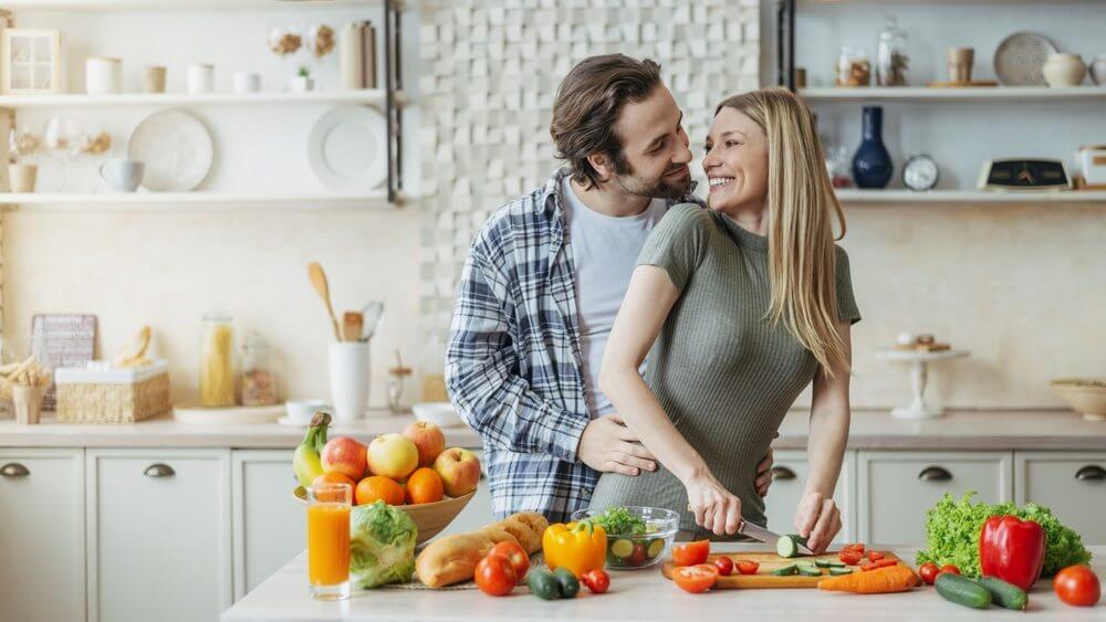 young happy couple cooking together