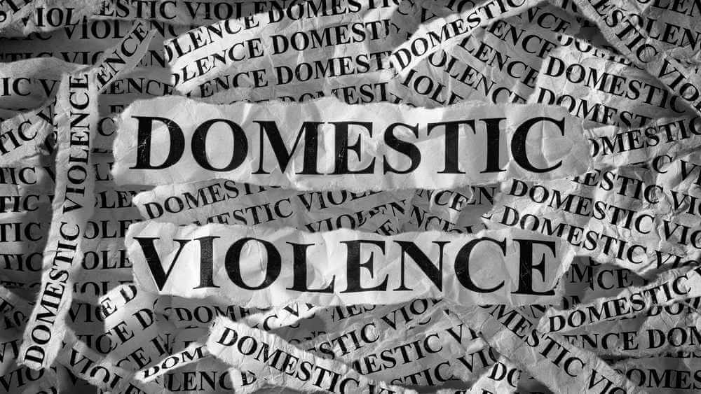 domestic violence is written in many pieces of rumpled paper