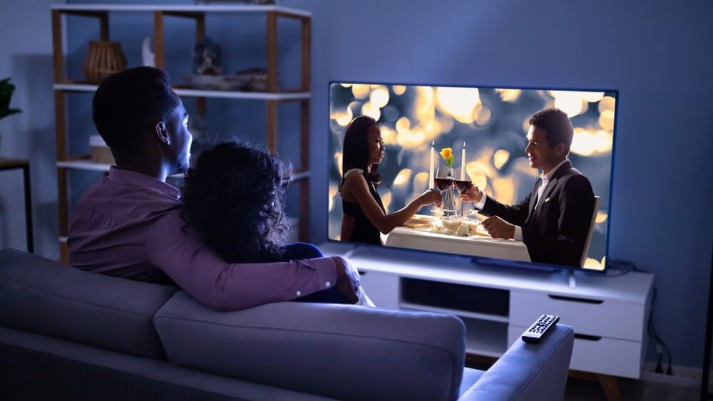 Young family watching tv at home