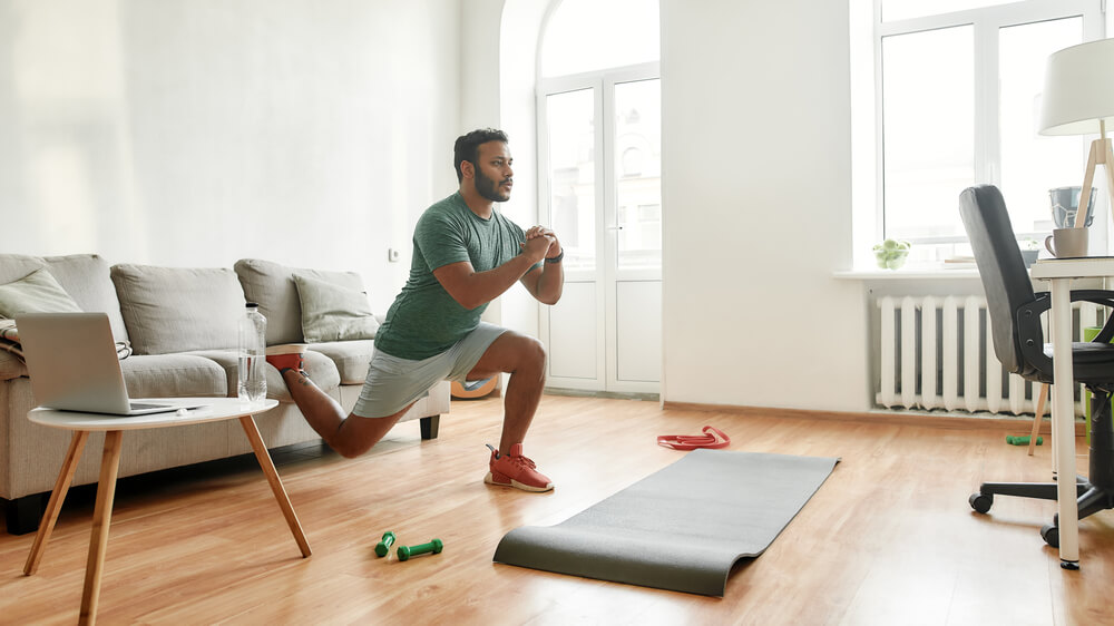 young active man having a workout session in his lounge